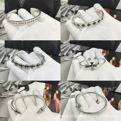 Silver cuff bracelets and rings on white fabric