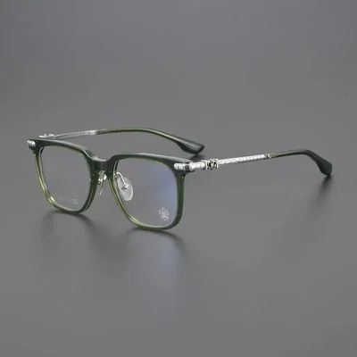 Dark green rectangular glasses frames with silver hinges on a grey surface