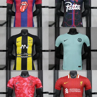 Football shirts in red, black, yellow and teal hanging on a rail