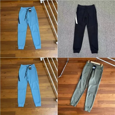 Joggers in light blue, navy and sage green photographed on a wooden floor