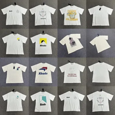 Rows of printed T-shirts in black and white laid out on a grey floor